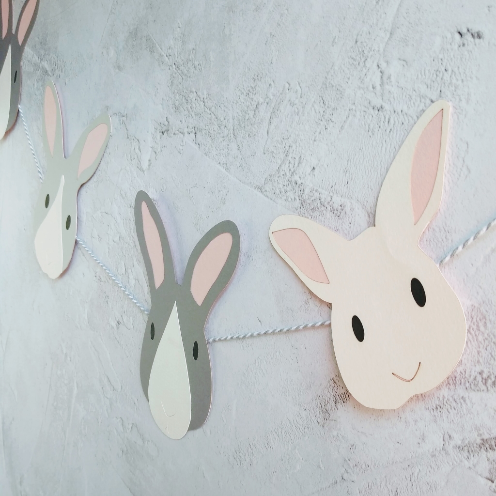 Easter Bunny Garland hung on grey wall, with white bunny, dark grey and white bunny and pale grey and white bunny threaded onto grey and white twine.