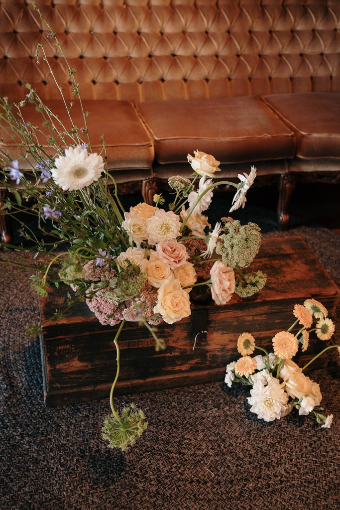 Floral arrangement on coffe table with brown leather sofas